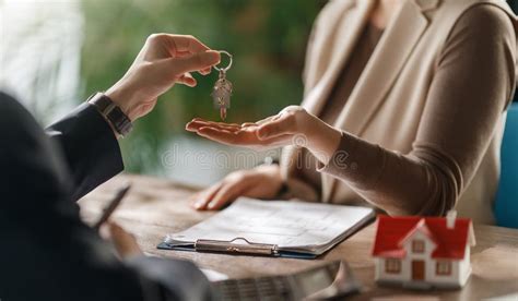 real estate agent handing  house keys   homeowner
