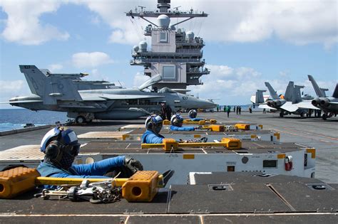 USS Gerald R. Ford (CVN 78) lines up spotting dollys on the flight deck