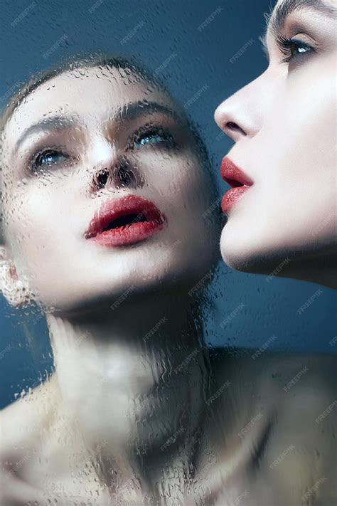 Premium Photo | Beautiful girl looking in wet mirror woman with red lips
