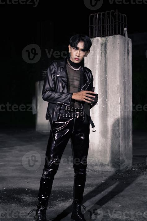 an asian man in a black leather jacket posing like a motorcycle gang