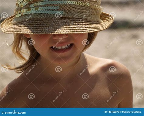 Little Girl in a Beige Sun Hat with a Smile Stock Image - Image of ...