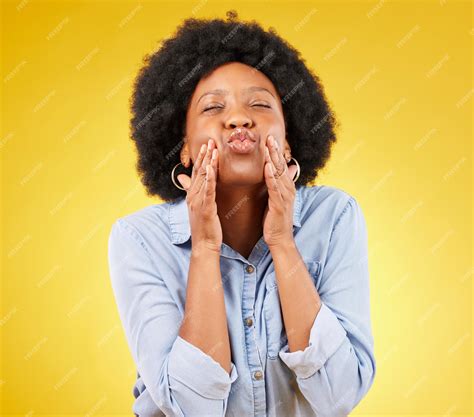 Premium Photo | Happy blow kiss and black woman in a studio for love