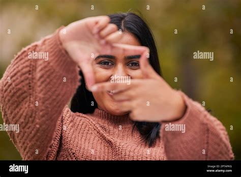 Hands frame, woman and eyes look through fingers while framing happy ...