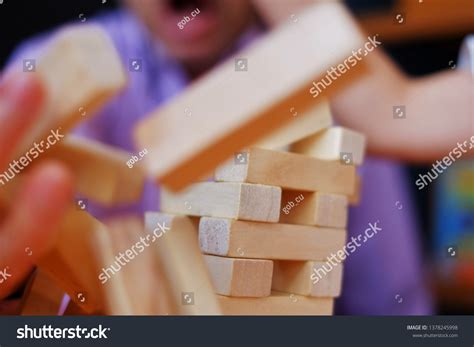 stacked wooden block tower falling  stock photo
