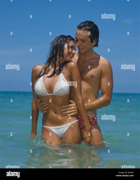 attractive young couple embracing  beach stock photo alamy