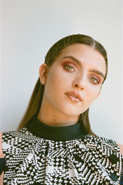 Download Mae Muller striking a pose during a photoshoot Wallpaper