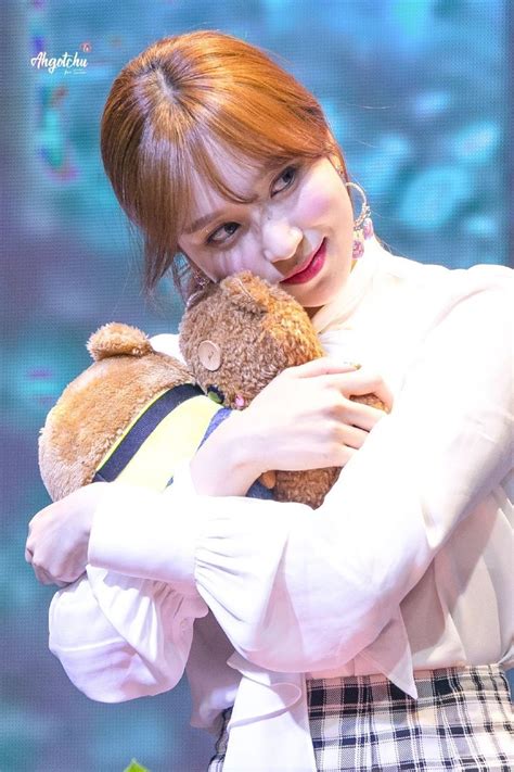 Mina hugging her plushies