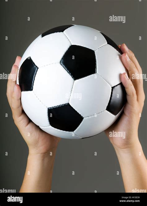 hand holding soccer ball stock photo alamy