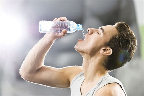 man drinking water bottle