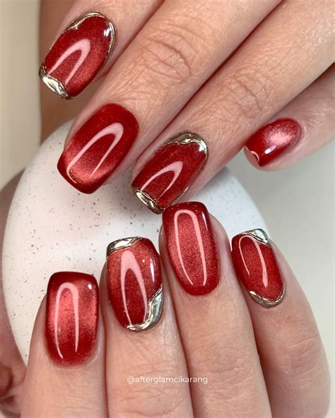 red cat eye nails  metallic silver accents   chic