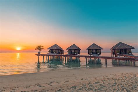 Premium Photo | Maldives island sunset. water bungalows resort at islands beach. indian ocean ...