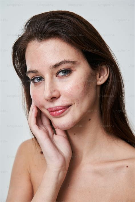 Young beautiful freckles woman face portrait with healthy skin