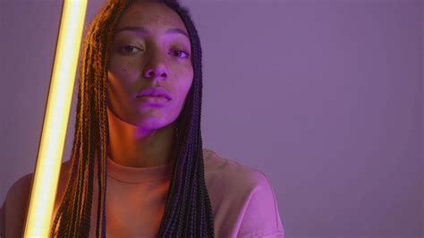 A Young Woman Posing with a Neon Light · Free Stock Video