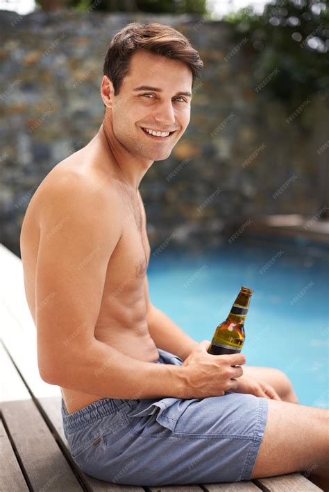Premium Photo | Man relax and happy by swimming pool with beer to drink