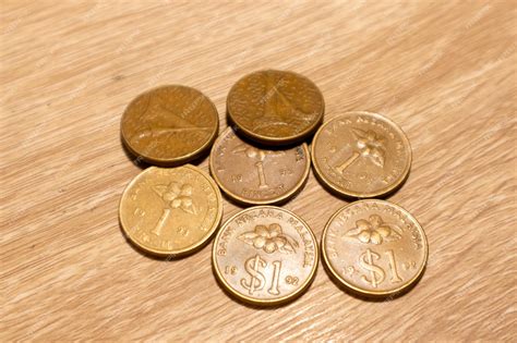 premium photo malaysian ringgit coins   wooden background