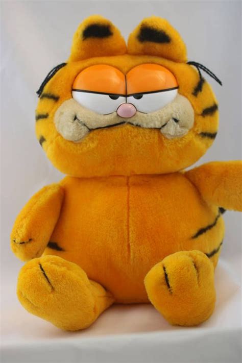 a yellow stuffed animal with an angry look on it's face and eyes ...