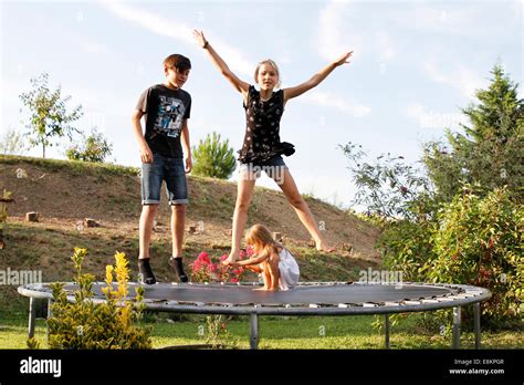 Children playing on a trampoline Stock Photo - Alamy
