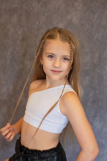 Premium Photo | A beautiful longhaired girl with pigtails in a white ...