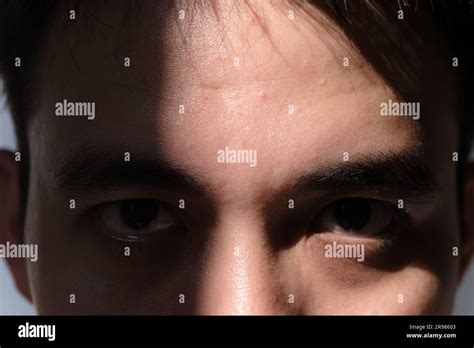 close  shot   partial face   man covered  shadow
