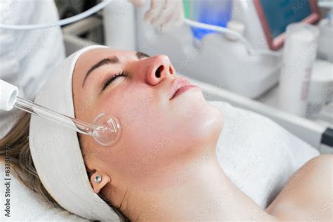 young woman receiving face lift treatment  high frequency wand