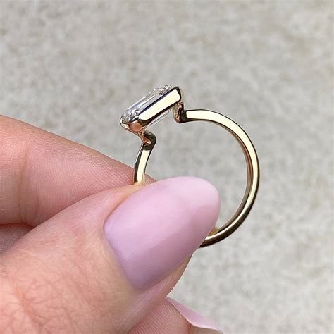 2ct east west emerald cut moissanite half bezel solitaire engagement