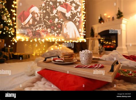 Video projector screen displaying Christmas movie in room, focus on ...