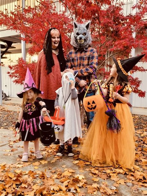 A picture of a family, dressed up as a vampire, ghost, werewolf, and witch for Halloween. 3 ...