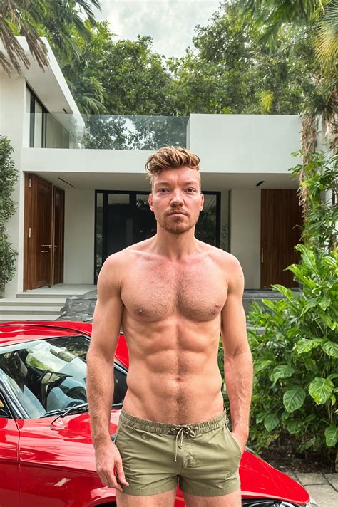 Instagram influencer man wearing swim shorts standing in front of