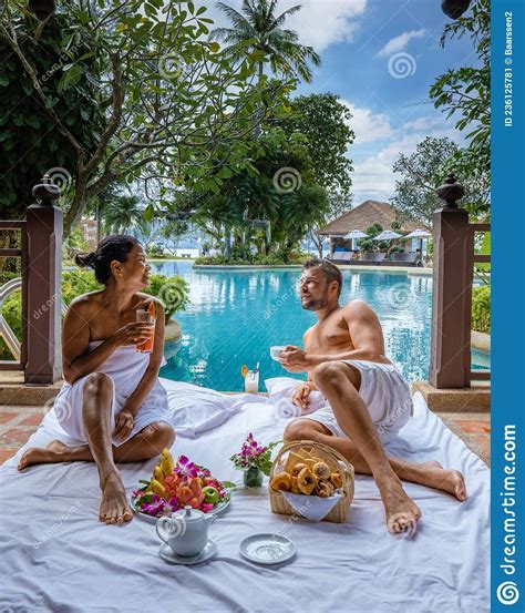 Couple Breakfast by the Pool , Man and Woman on Vacation in Thailand