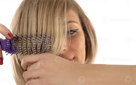 Closeup on young woman combing hair 16605313 Stock Photo at Vecteezy