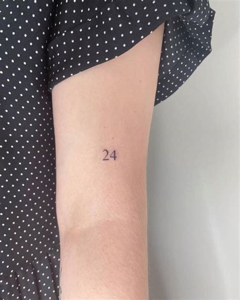 tiny number  tattooed   upper arm