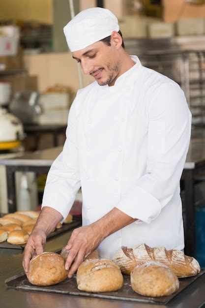 Premium Photo | Baker checking freshly baked bread