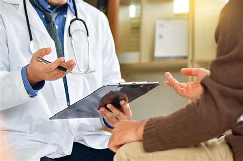 Doctor Sitting And Working A Professional Physician In A White Medical