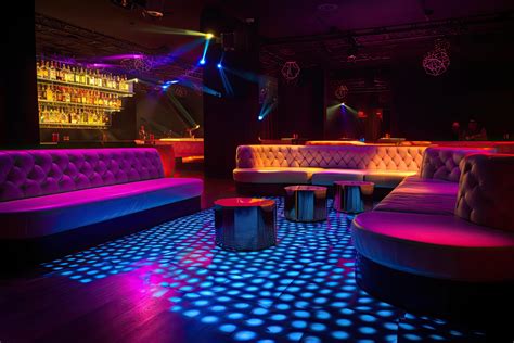 colorful interior of bright and beautiful night club with dark seats
