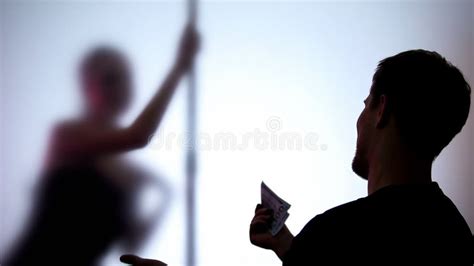 man holding dollars  watching seductive dance striptease  night