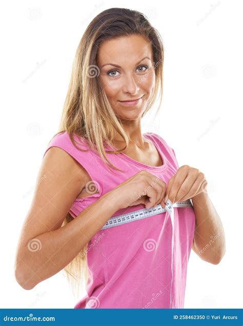 Finding the Right Fit. Studio Shot of a Gorgeous Woman Measuring Her