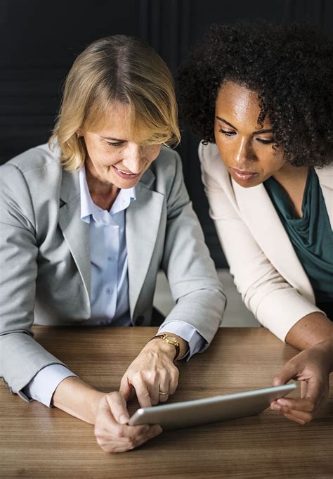 women watching gray tablet computer adults blonde business people