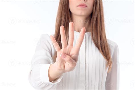 young girl is stretched out in front of hand and four fingers shows