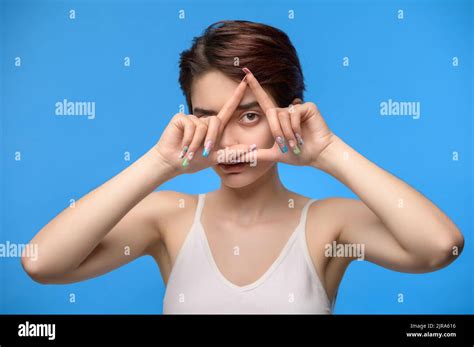 young brunette woman   triangle finger frame stock photo
