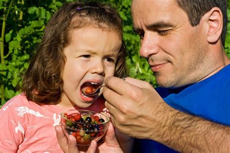 Little girl eating fruits stock image. Image of adult - 15165743