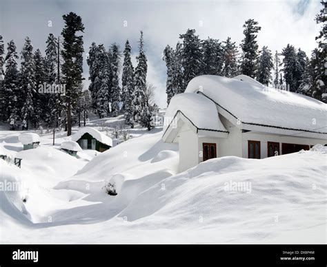 India, Kashmir, Gulmarg, Himalayan Ski Resort, houses almost buried in heavy snowfall Stock ...