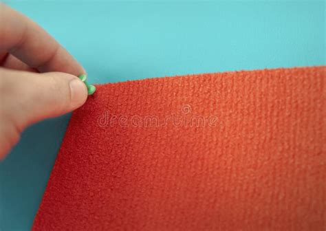 A Man`s Hand Attaches a Red Rug with Push Pins. Copy Space. Textures ...
