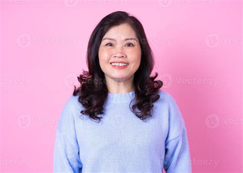 Portrait of middle aged Asian woman on pink background 7587121 Stock