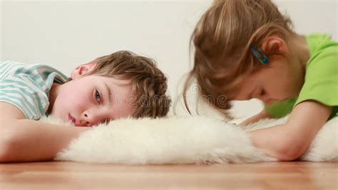 boy   girl lie  wooden floor  stock footage video
