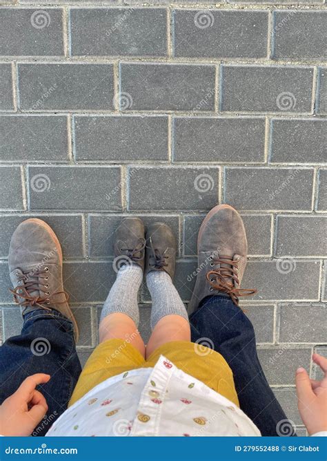 Big Feet, Small Feet. Concept of a Father Teaching His Son To Walk