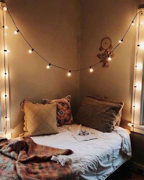 Corner bed, white comforter, dark brown pillow, warm-colored throw ...