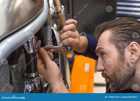 Photo of a Man Fixing Something in a Mechanical Workshop Stock Photo ...