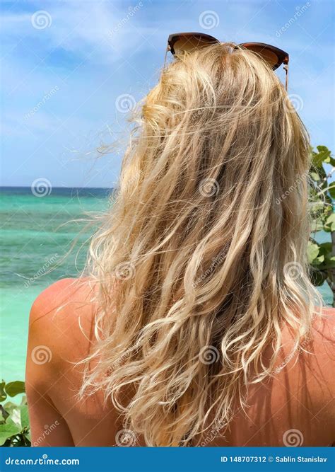 Tanned Blonde Looking at the Sea. Close-up. Stock Photo - Image of