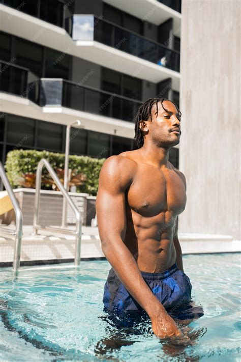 Premium Photo | Handsome and sexy black man posing in the pool
