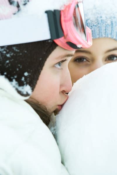 Teenage girl kissing snowball close-up friend in - Royalty free image ...